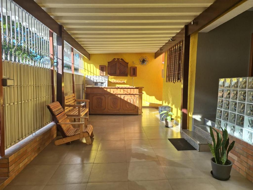 a room with a porch with chairs and a table at Hostel My House quartos perto do aeroporto de Guarulhos in Guarulhos