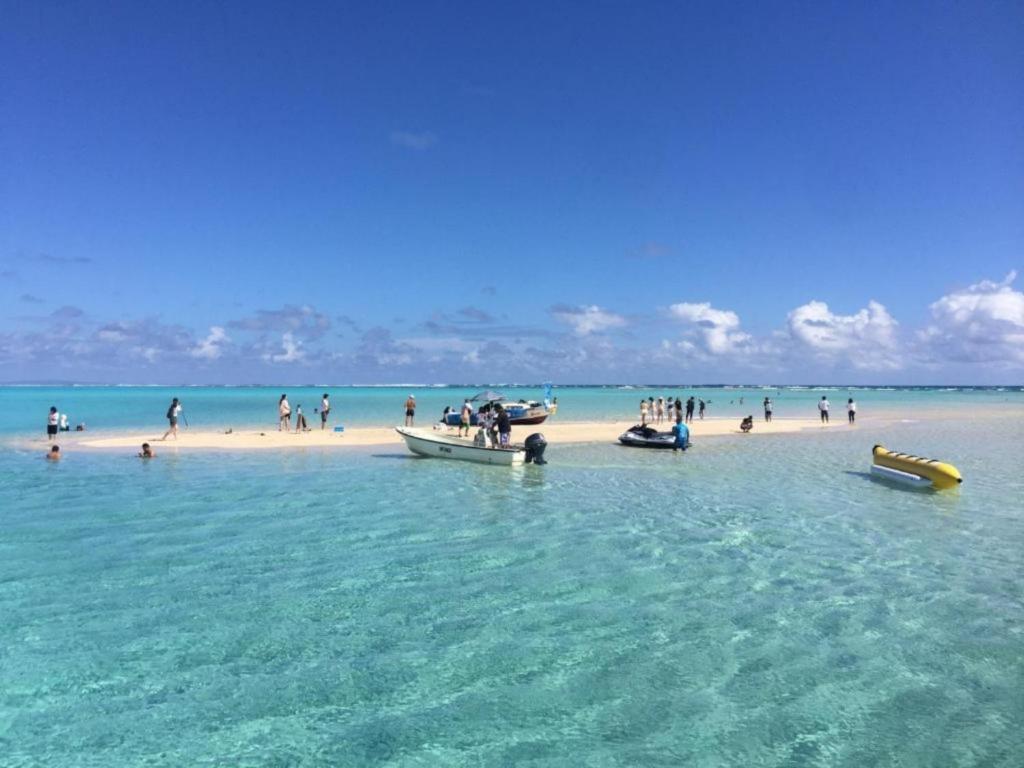 a group of people on a beach with boats in the water at Yoron Tandy-House - Vacation STAY 78648v in Yoron