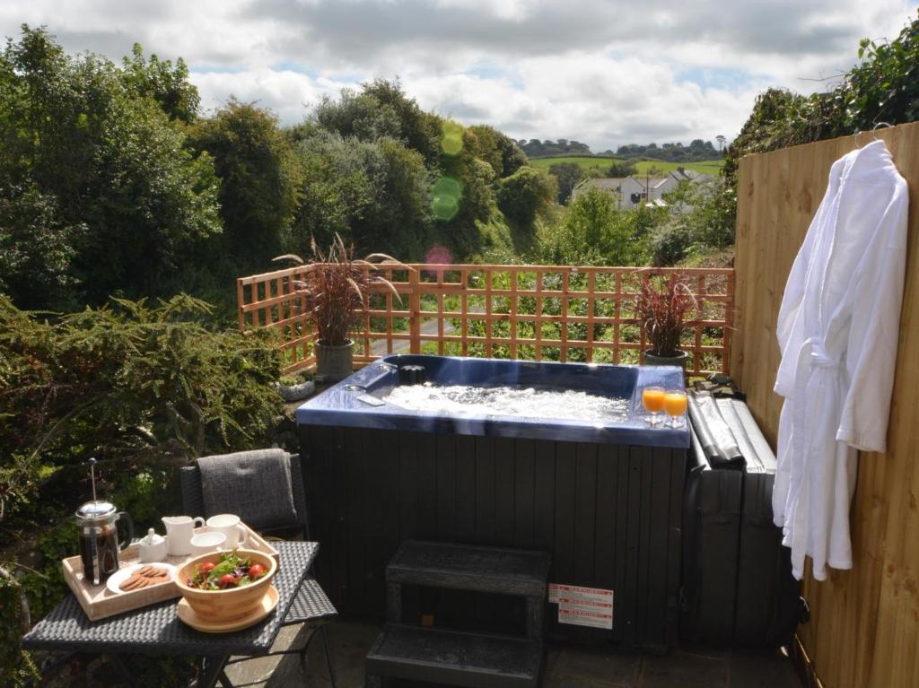 a hot tub in the middle of a garden at 1 Bed in Instow 52974 in Instow