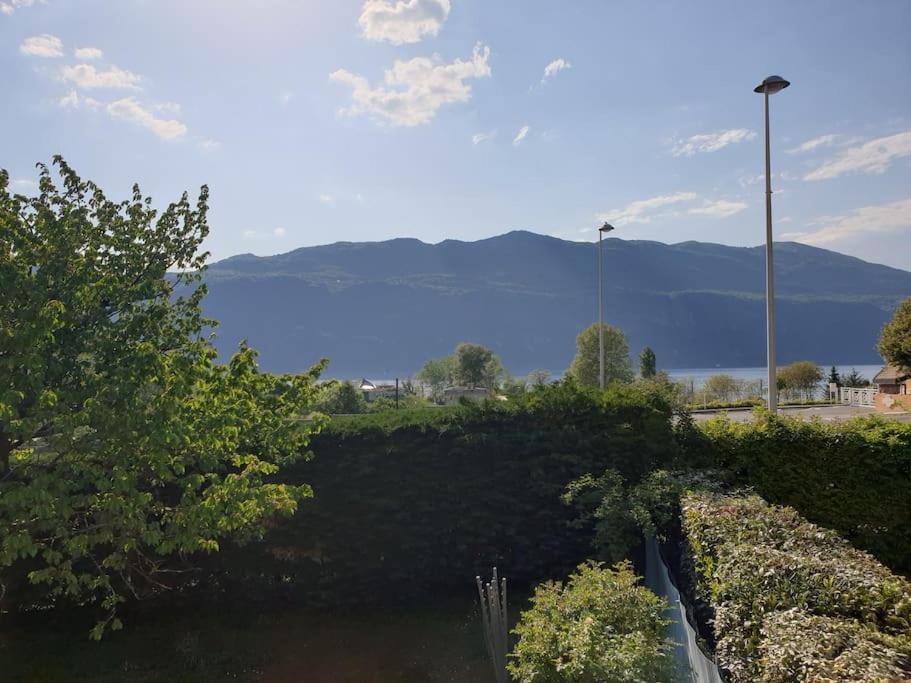 Vue sur une étendue d'eau avec des montagnes en arrière-plan dans l'établissement maison proche du lac, à Aix-les-Bains
