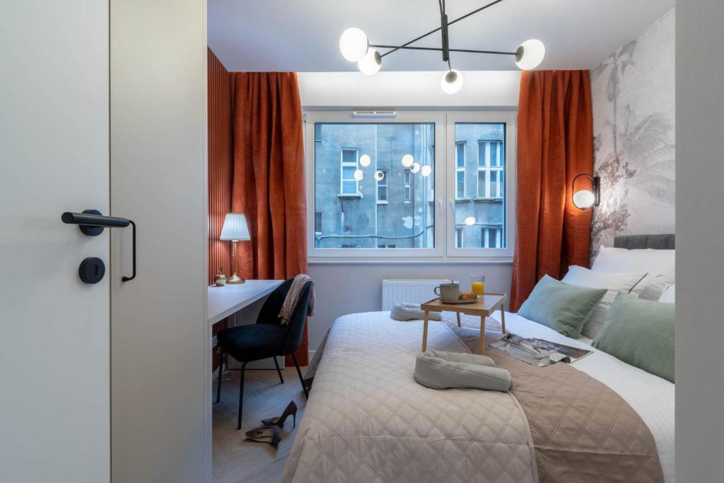 um quarto com uma cama, uma secretária e uma janela em Lucky Seven No. 2 em Poznań