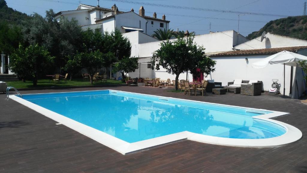 a swimming pool in front of a house at Agriturismo Malena in Rossano