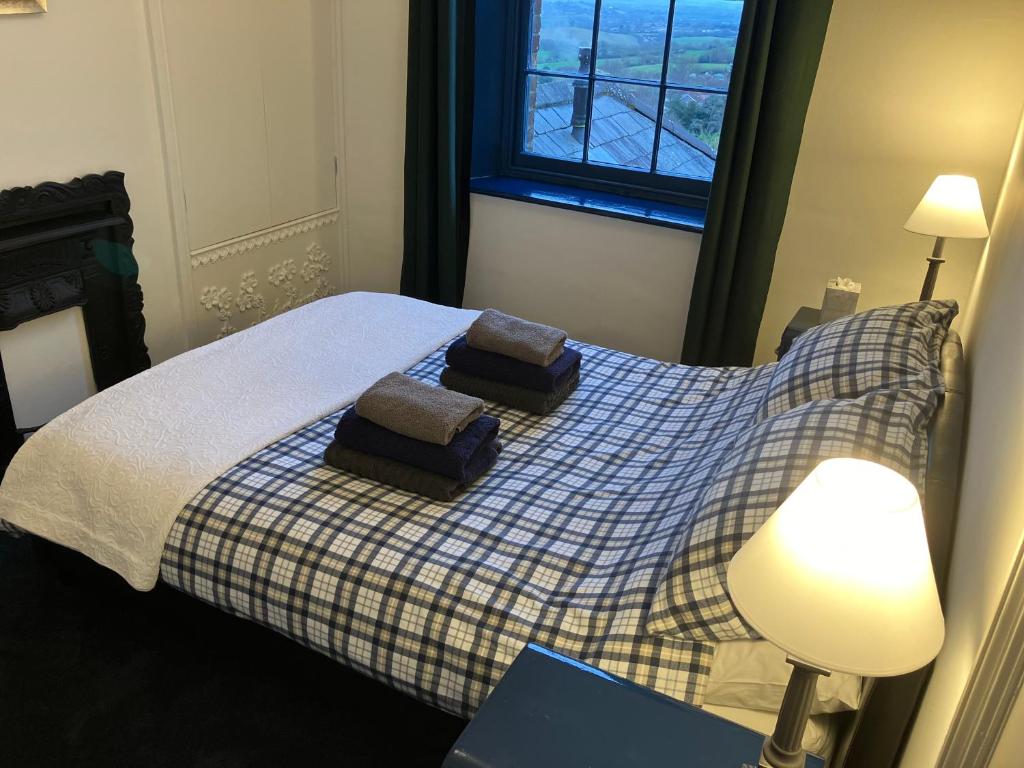 a bedroom with a bed with two pillows on it at Shaftesbury Centre in Shaftesbury
