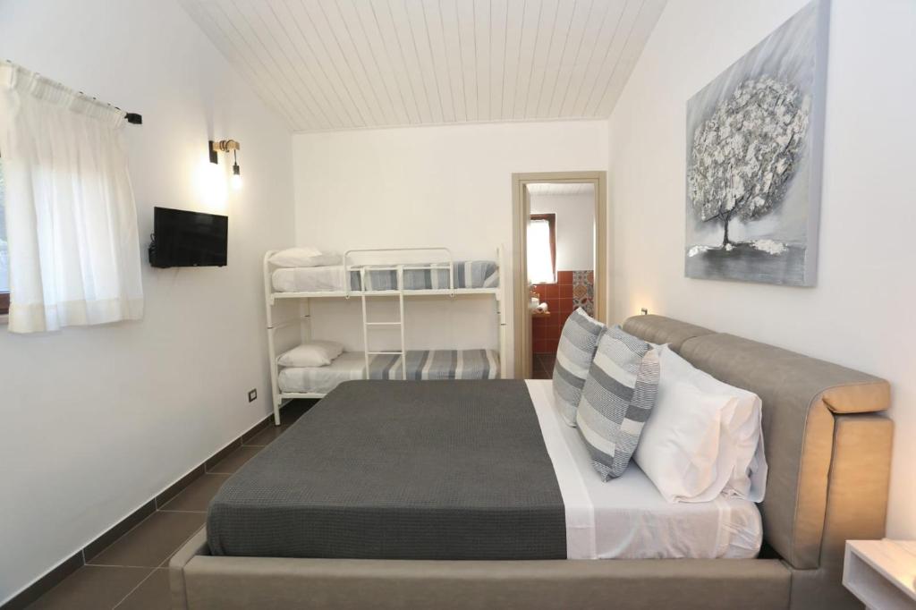 a bedroom with a bed and a couch at Alpaca Etna Rooms da Mariagiovanna in Linguaglossa