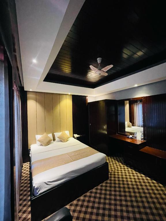 a hotel room with a bed and a bathroom at Hotel Istanbul in Sylhet