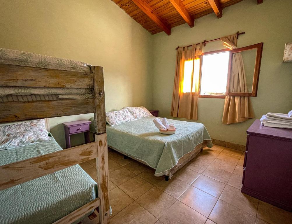 a bedroom with two bunk beds and a window at Narciso Home in Cafayate