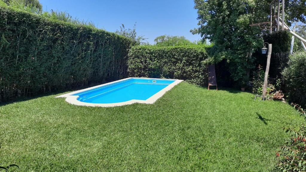 a small blue swimming pool in the grass at Casa en San Lorenzo in San Lorenzo