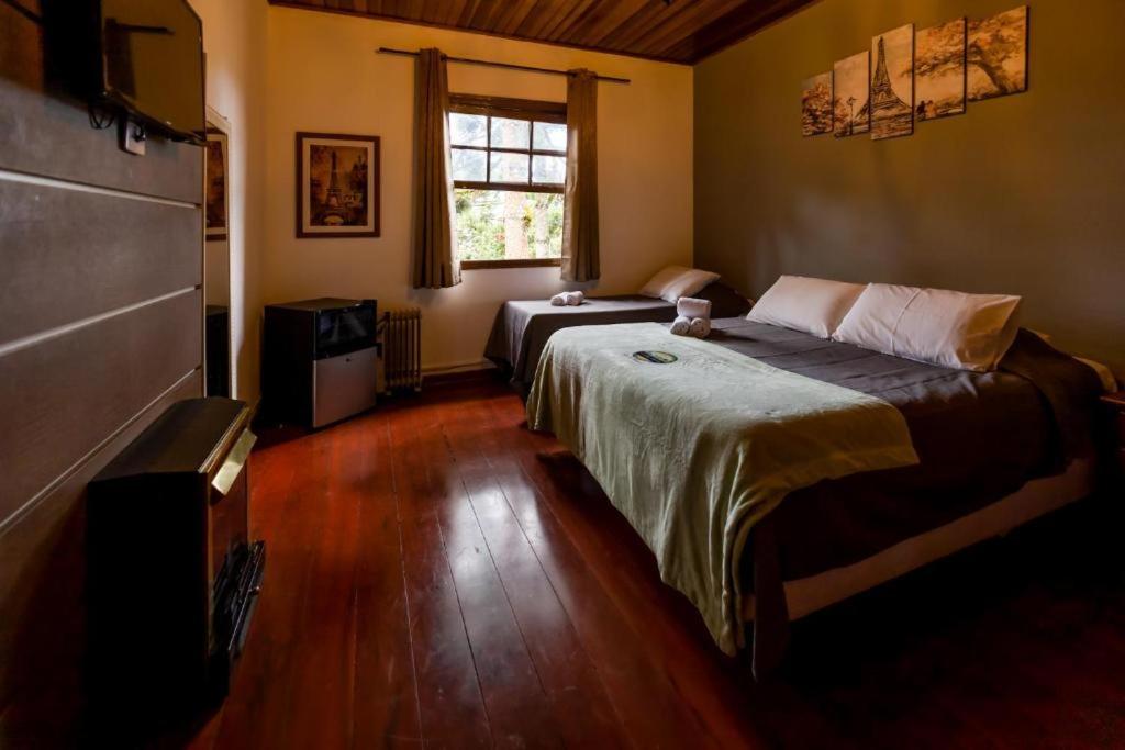 Voodi või voodid majutusasutuse Pousada Casa de Campos Guest toas