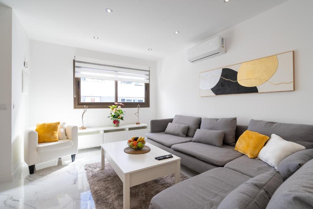 a living room with a couch and a table at Aqua Viva - Playa San Juan in Playa de San Juan