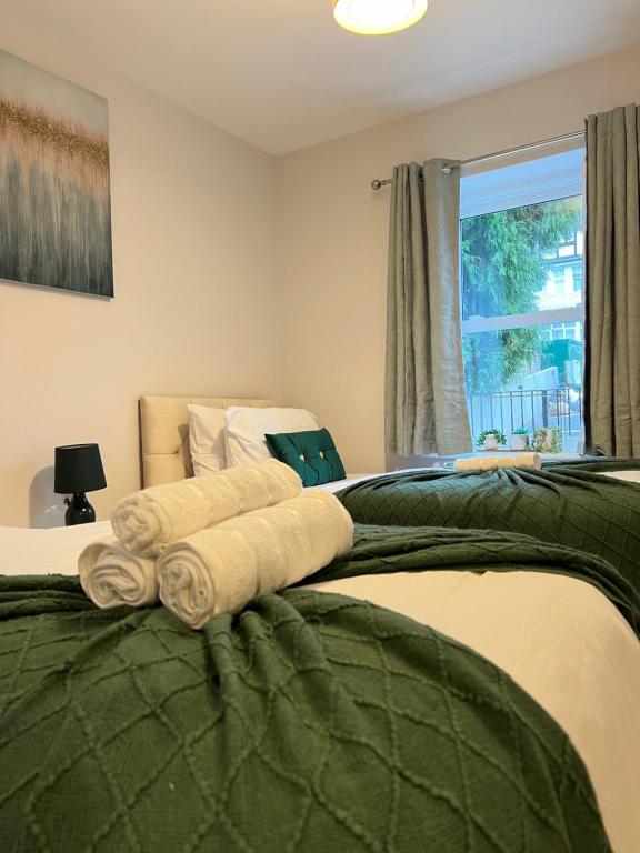 a bedroom with a bed with towels on it at Port of Dover Apartments in Kent