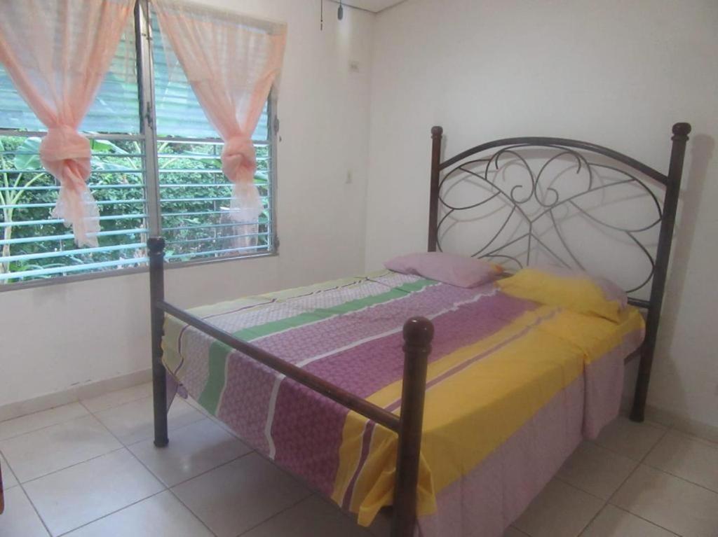 a small bed in a room with a window at yayaya coronado playa exelente precio in Playa Coronado