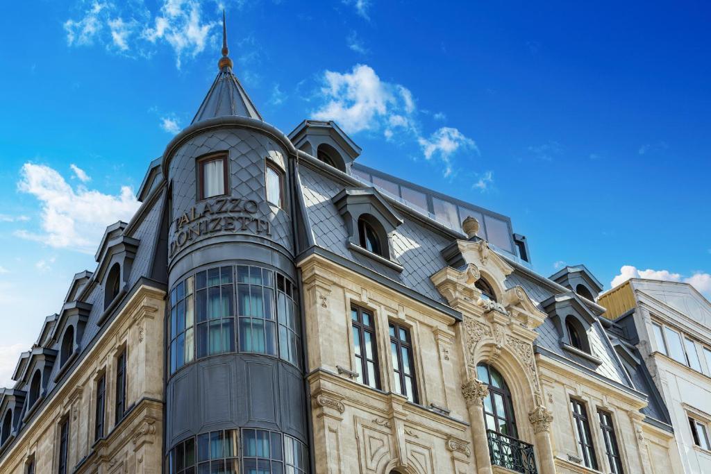 a building with a glass tower on top of it at Palazzo Donizetti Hotel - Special Class in Istanbul