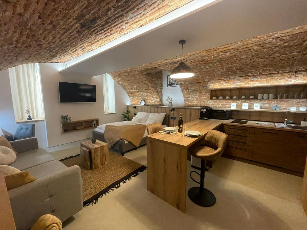 a living room with a couch and a table in a room at UnderStreet studio with private parking in Košice