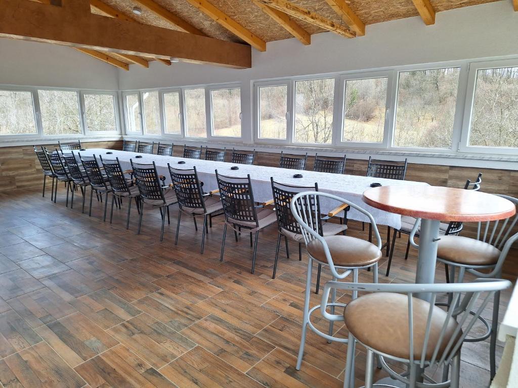 a room with chairs and tables and a bar at Vikendica Avram-Plane 