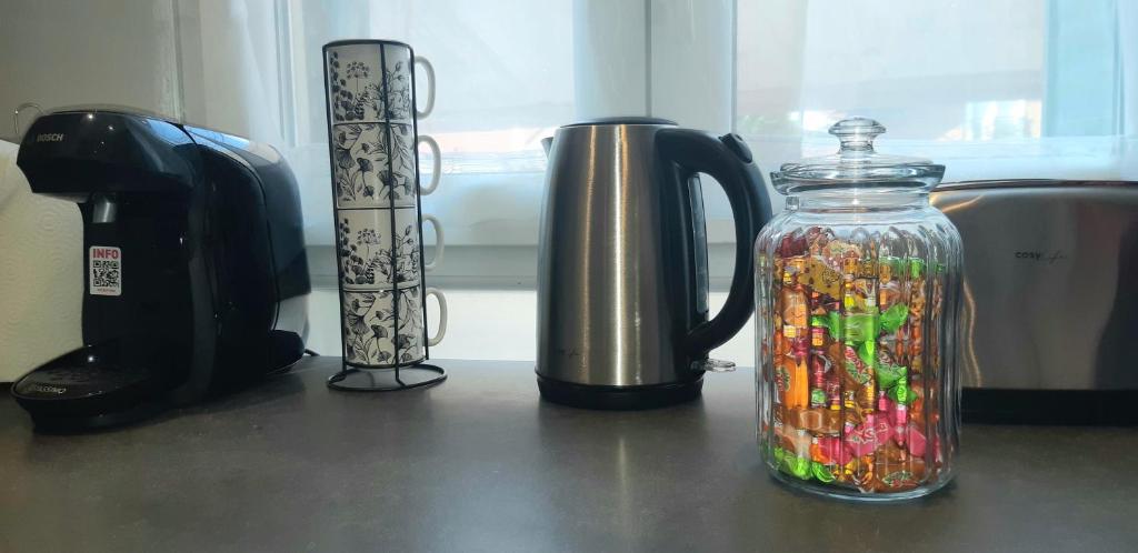 a glass jar filled with candy on top of a counter at Warm Studio en duplex proche Paris et Disney in Neuilly-Plaisance