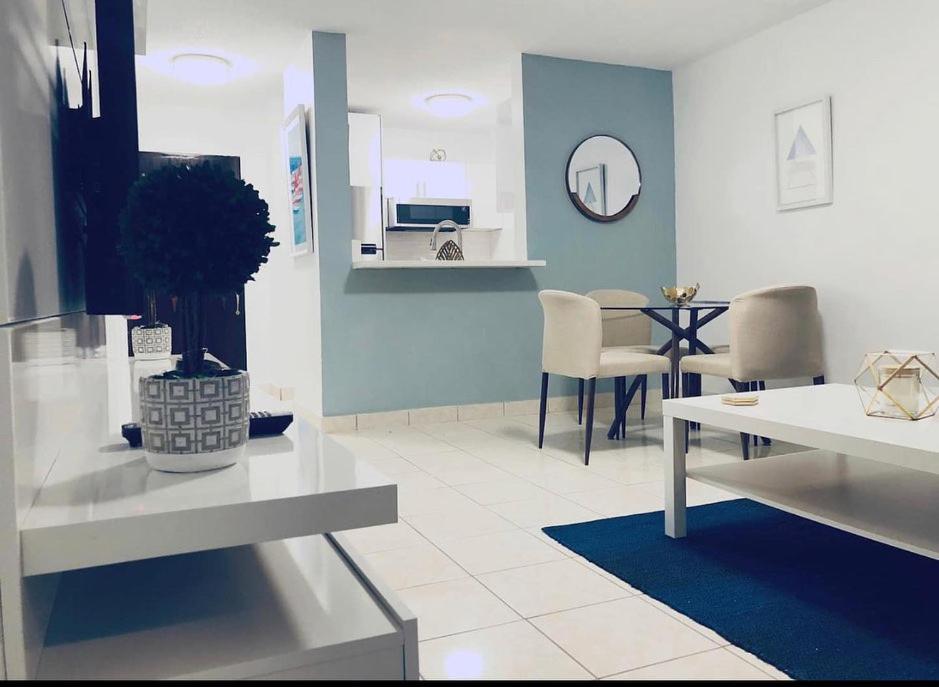 uma sala de estar com uma mesa e uma sala de jantar em Isla Verde Beach Modern apartment em San Juan