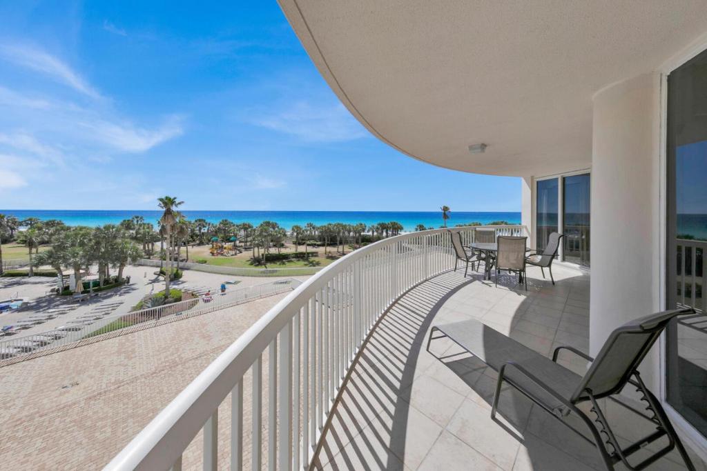 a balcony with chairs and a view of the ocean at St Maarten 402 a Luxury Beachfront 3 Bedroom Condo Elevator Opens Into Unit in Destin