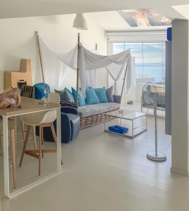 a living room with a bed and a table and a desk at Radazul Seafront Marina 9 in Radazul