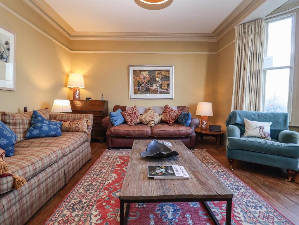 a living room with two couches and a coffee table at 11a Market Cross Place in Aldeburgh