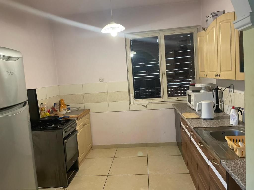 a kitchen with a refrigerator and a stove top oven at House in Budapest