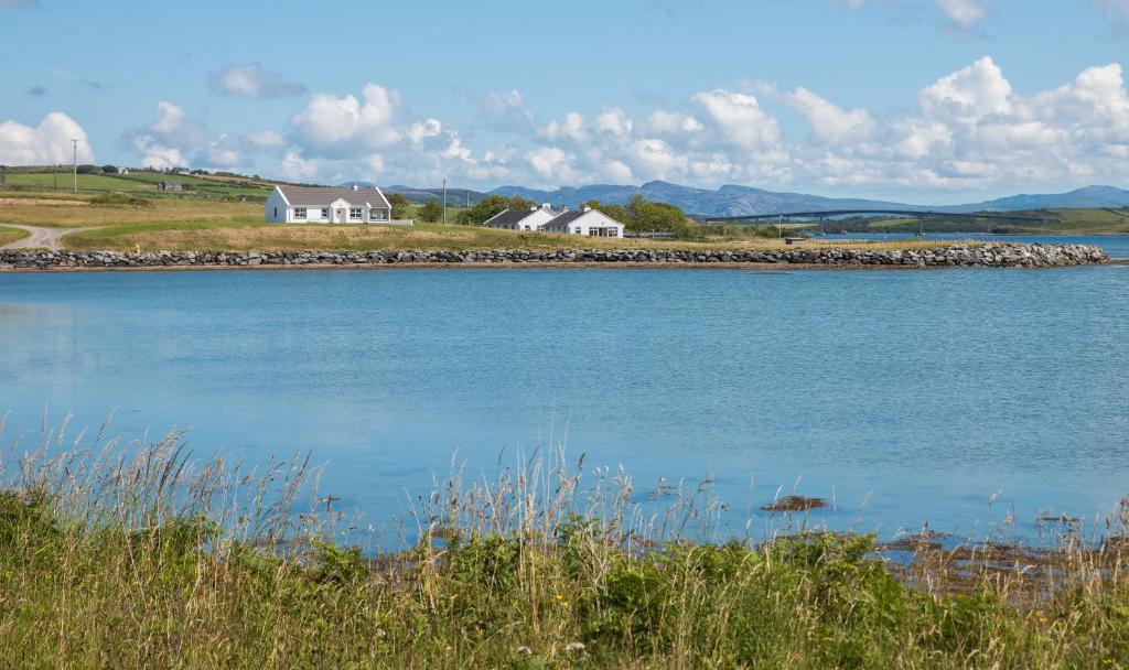 a large body of water with a lighthouse at Doherty Farm Holiday Homes in Downings