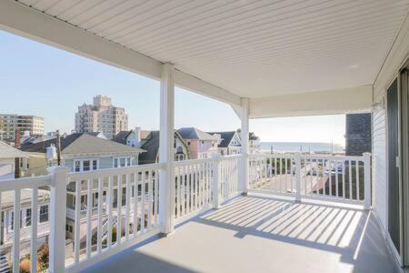 a white porch with a view of the ocean at Bartram Dream House II - Bartram Beach Retreat in Atlantic City