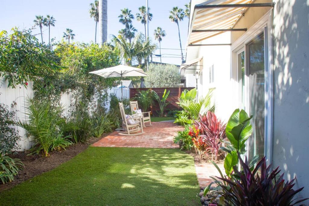 a patio with an umbrella and a table and chair at Adorable Octopus Hideaway: 2 min walk to the beach in Del Mar