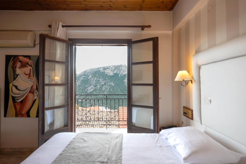 Postel nebo postele na pokoji v ubytování Kouros Hotel