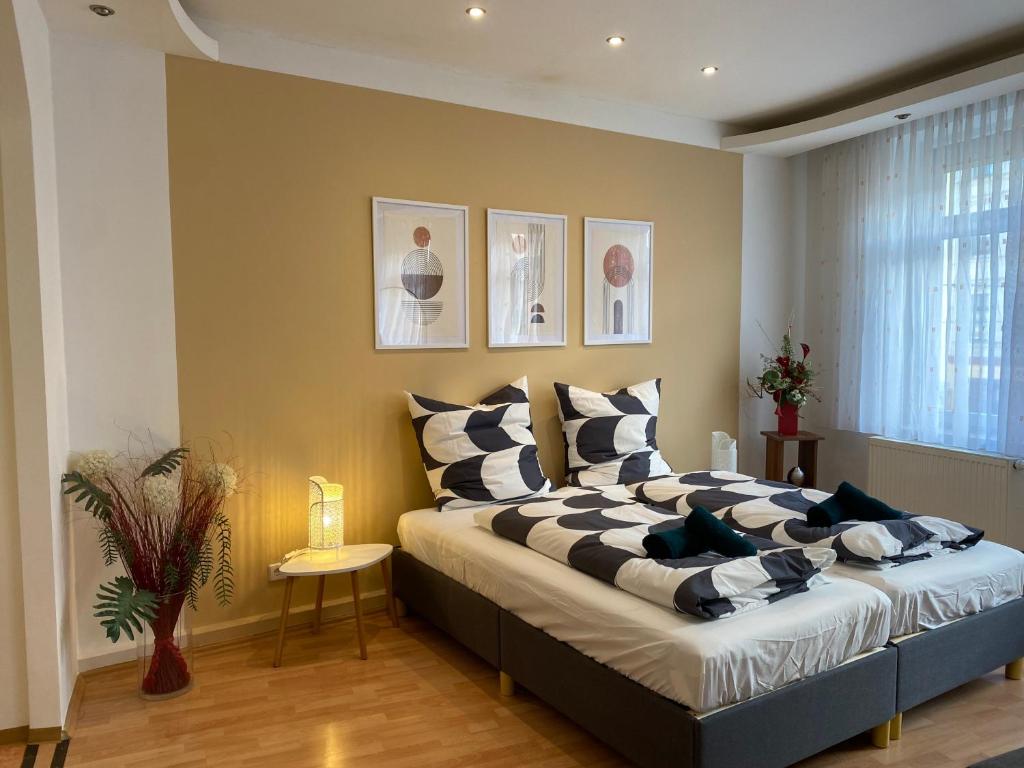 a bedroom with a large bed with pillows on it at Modern & cozy Rooms Leipzig-Gohlis in Leipzig