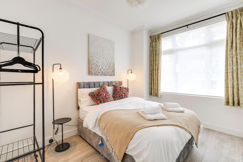Un dormitorio con una cama grande y una ventana en Relocators, Medical Staff, Families en Luton