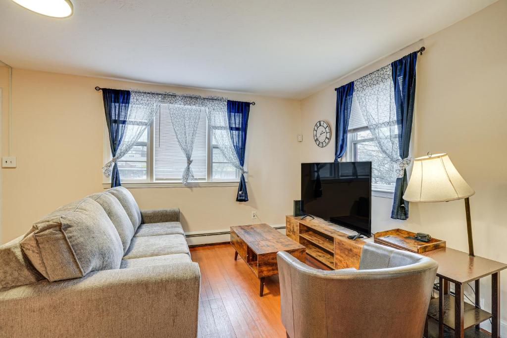 a living room with a couch and a tv at Pet-Friendly Burlington Home 17 Mi to Boston! in Burlington