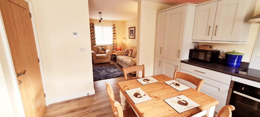 eine Küche und ein Esszimmer mit einem Holztisch in der Unterkunft Manby Fields, Manby in Louth