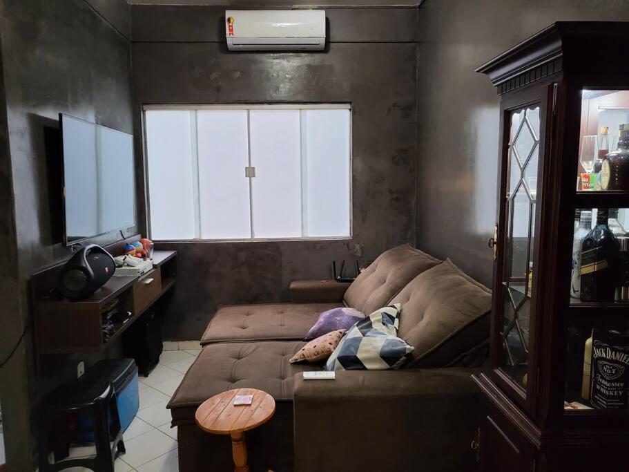 een woonkamer met een bank en een tafel bij Apartamento inteiro em condomínio in Rio Branco