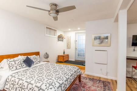 a bedroom with a bed and a ceiling fan at Cozy Private Apt near Downtown in Burlington