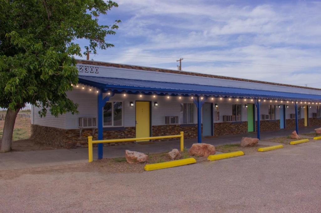 a building with a row of rocks in front of it at Moapa Motel in Moapa