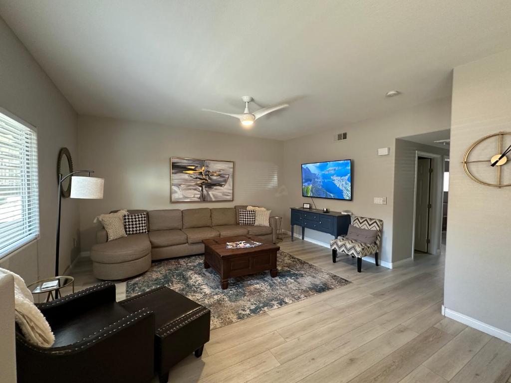 a living room with a couch and a table at Golfer’s Oasis Condominium at Hawk Ridge in Mesquite