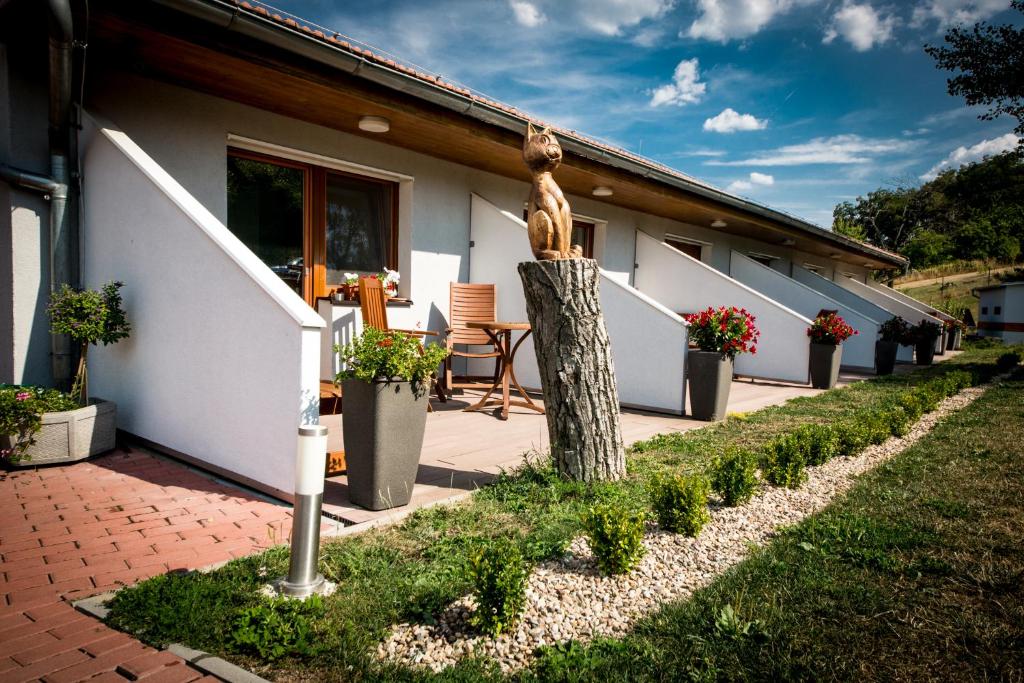 a house with a statue of a woman on a porch at Penzion Proneco in Klentnice