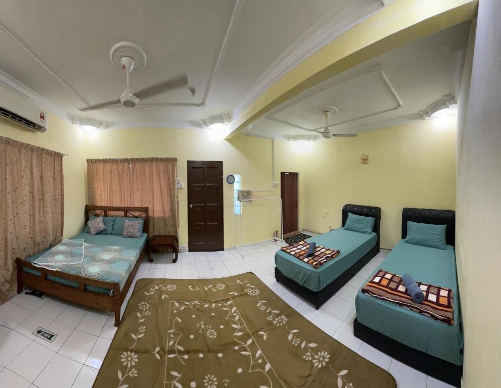 a living room with two beds and a couch at AllOfUs GuestRoom in Kuala Lumpur