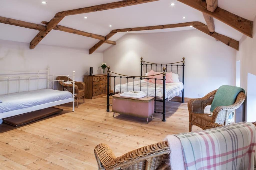 a bedroom with two beds and two chairs at Number 29, a Grade two listed house in Masham in Masham