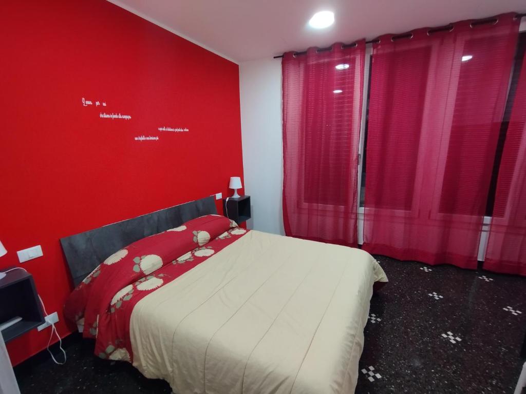 a red bedroom with a bed with red walls at DOMUS SUPERBA in Genova