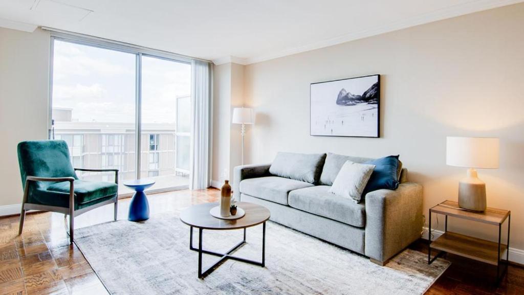 a living room with a couch and a chair at Landing Modern Apartment with Amazing Amenities (ID2805X39) 