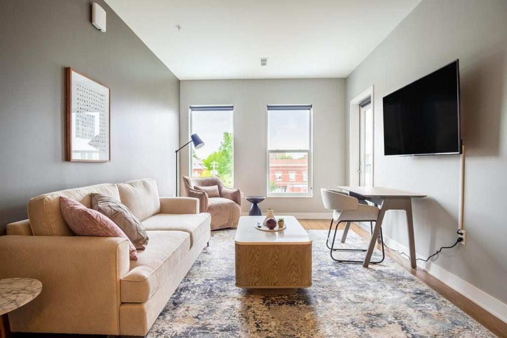 a living room with a couch and a table at Landing Modern Apartment with Amazing Amenities (ID5034X58) in Tower Grove