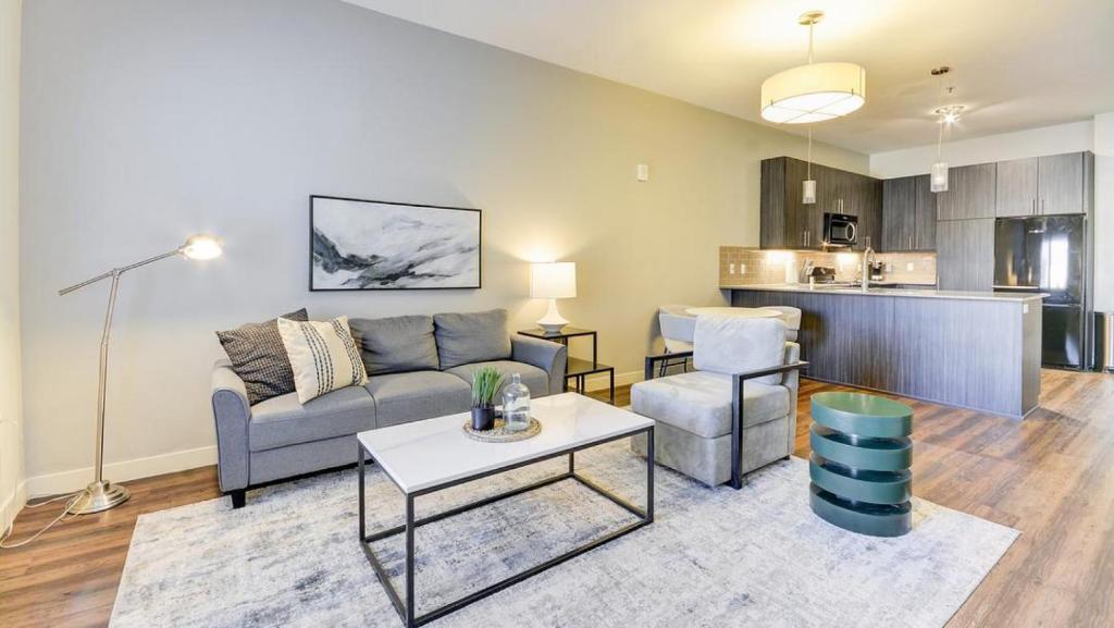 a living room with a couch and a table at Landing Modern Apartment with Amazing Amenities (ID6644) in Sandy