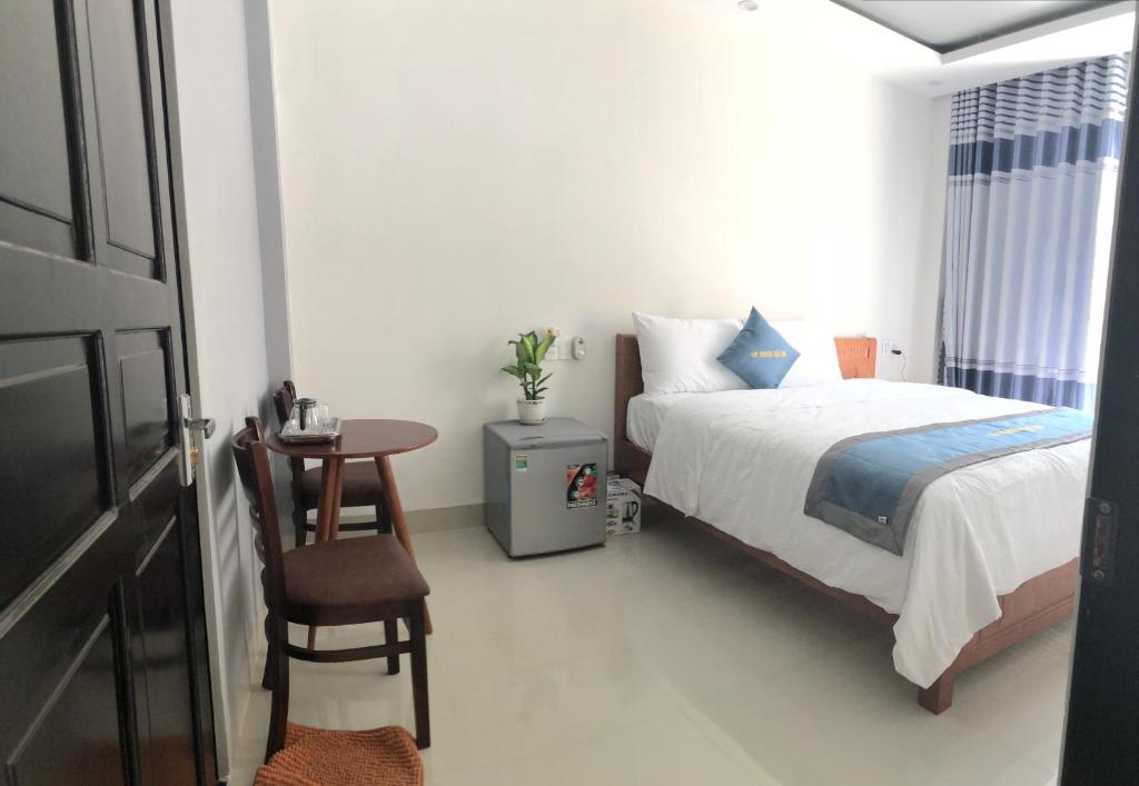 Postel nebo postele na pokoji v ubytování Vip House Hoi An Homestay