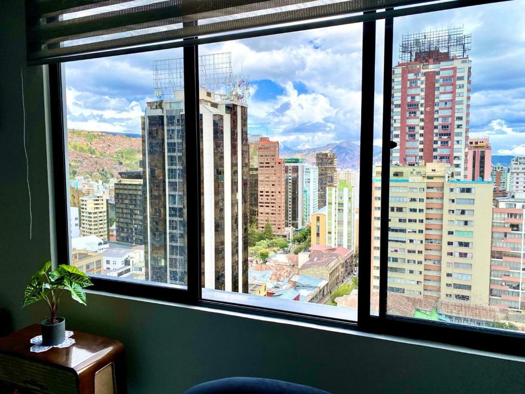 a view of a city from a large window at Confort y comodidad in La Paz