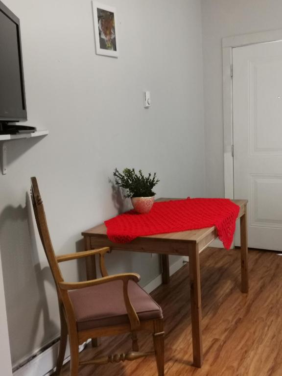 a table with a red blanket on top of it at Coquihalla Motel in Hope