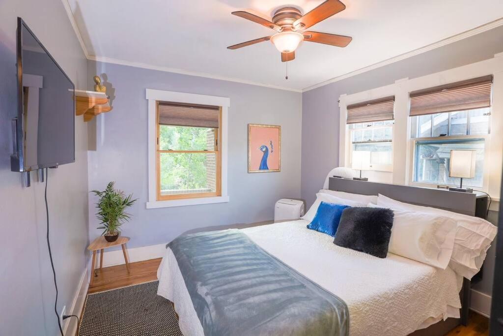 a bedroom with a bed with a ceiling fan at Excellent Location Mins from Dining & DT! in Denver