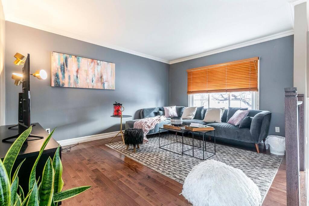 a living room with a couch and a table at Fancy 4BDR near DT free parking in Brossard
