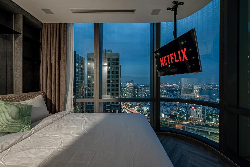 a hotel room with a view of a city at Landmark 81 And Vinhomes PANORAMA - ANGIA Hospitality in Ho Chi Minh City