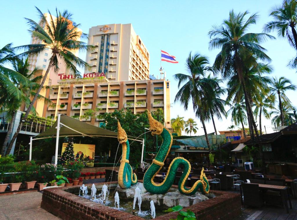 a fountain in front of a hotel with a building at Kosa Hotel & Wellness Center -SHA Certified in Khon Kaen